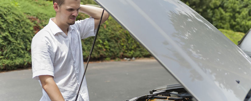 Man checking underneath the bonnet