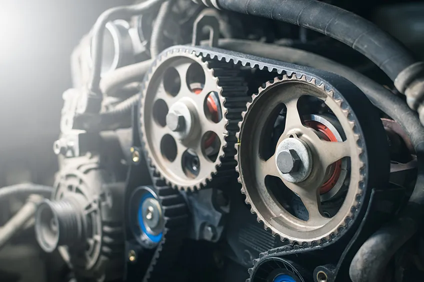 A close-up of a cambelt or timing belt within a car’s engine