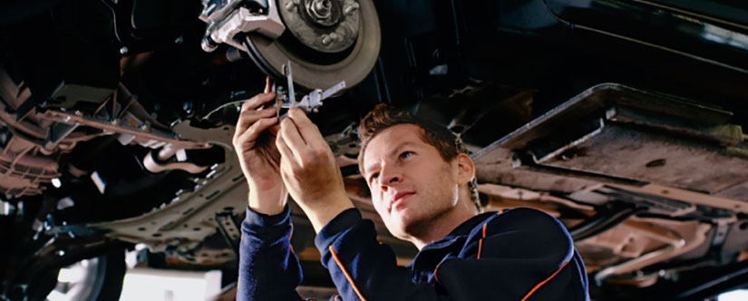 Mechanic servicing the underneath of a car