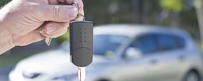 Man handing over the keys to a car