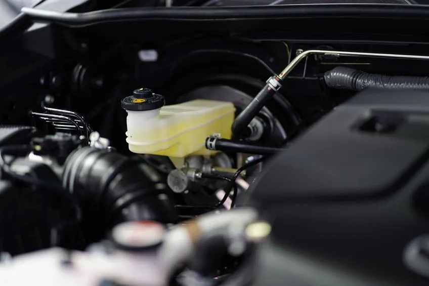 an open bonnet with the brake fluid reservoir clearly visible within.