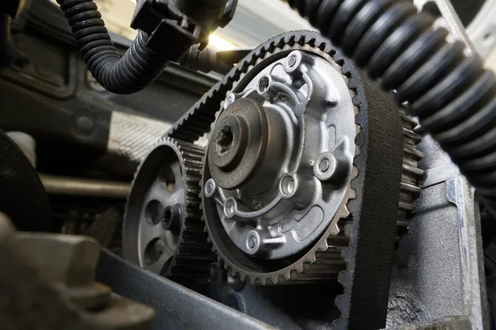 A timing belt or cambelt fitted around the camshaft and crankshaft in a car engine.